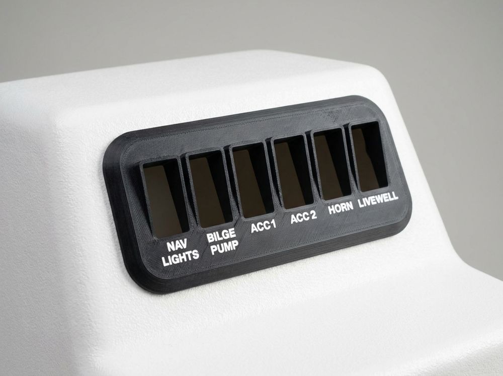 Concept render of a black printed switch panel bezel with six labeled switch openings on a white boat console